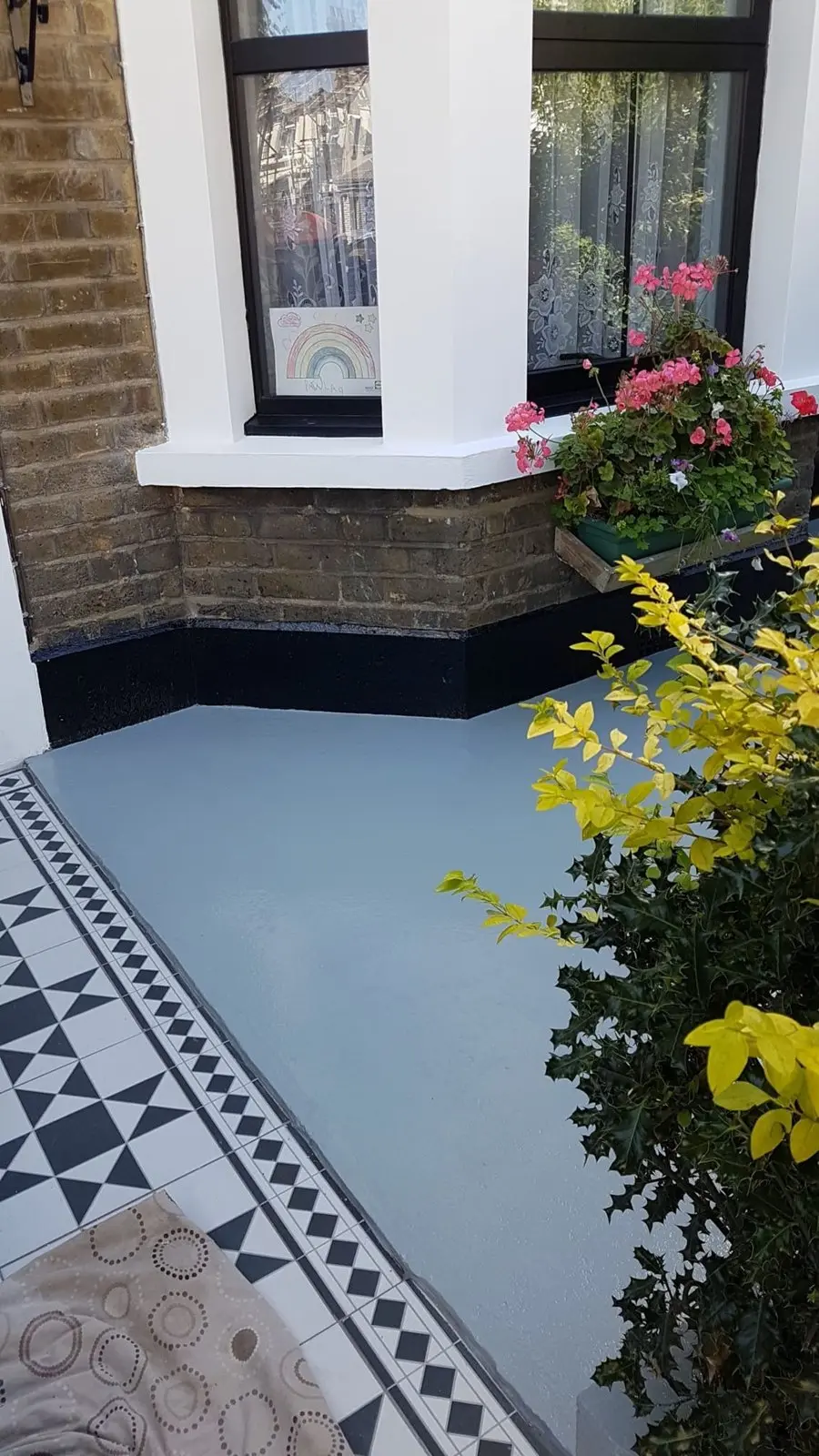 Victorian-style black and white mosaic tiled garden path